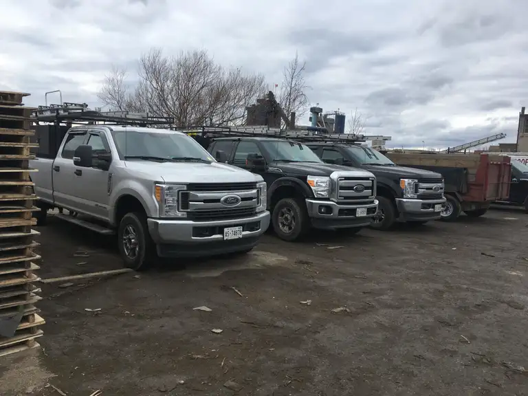 Jin Li Roofing service truck on a completed job site