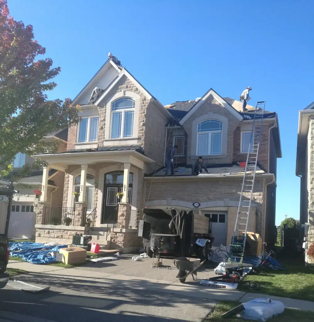 Roofing crew installing shingles